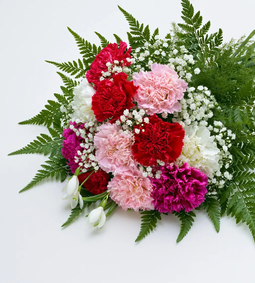 Colorful floral arrangement of multi colored carnations and green foliage